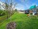 The backyard features a well-maintained lawn, playground set and partial fence line at 9763 Brown Burrow St, Orlando, FL 32829