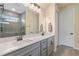 Bathroom with double sinks, modern fixtures, and a walk-in shower with tiled walls and glass doors at 9763 Brown Burrow St, Orlando, FL 32829