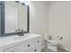 Bathroom featuring a white vanity, black hardware, and clean white finishes for a modern and refreshing look at 9763 Brown Burrow St, Orlando, FL 32829
