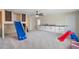 Spacious bonus room includes carpet flooring, built in cabinets, slide, and a barn door ladder at 9763 Brown Burrow St, Orlando, FL 32829