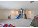 Spacious bonus room includes carpet flooring, built in cabinets, slide, and a barn door ladder at 9763 Brown Burrow St, Orlando, FL 32829