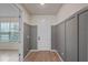 Welcoming entryway featuring modern trim, a front door, and hardwood flooring, with a view into another room at 9763 Brown Burrow St, Orlando, FL 32829