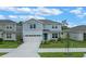 Charming two-story home boasts a well-manicured lawn and attached two car garage at 9763 Brown Burrow St, Orlando, FL 32829