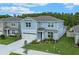 Beautiful two-story home with manicured lawn, landscaping, and an attached two car garage at 9763 Brown Burrow St, Orlando, FL 32829