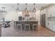 Open concept kitchen with an island, pendant lighting and stainless steel appliances at 9763 Brown Burrow St, Orlando, FL 32829