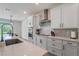 Modern kitchen features an island with barstool seating, stainless appliances and bright countertops at 9763 Brown Burrow St, Orlando, FL 32829