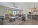Bright living room flows into kitchen with an island, stainless appliances and a dining area at 9763 Brown Burrow St, Orlando, FL 32829