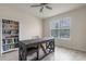 Bright office space with a rustic wooden desk, a white bookshelf, and ample natural light at 9763 Brown Burrow St, Orlando, FL 32829