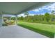Relaxing covered patio with a view of the expansive backyard and natural green surroundings, offering serene outdoor living at 9763 Brown Burrow St, Orlando, FL 32829
