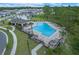 Aerial view of a community pool surrounded by lounge chairs and umbrellas perfect for outdoor relaxation at 9763 Brown Burrow St, Orlando, FL 32829