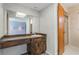 Bathroom showcasing wood vanity, large mirror, and a view through to the shower at 610 Palomas Ave, Ocoee, FL 34761
