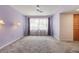 Charming bedroom with gray carpet, decorative wall lamps, and ceiling fan at 610 Palomas Ave, Ocoee, FL 34761