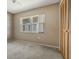 Comfortable bedroom with cozy carpet and a large bright window at 610 Palomas Ave, Ocoee, FL 34761