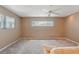 Well-lit bedroom features neutral walls, carpet, and a ceiling fan for added comfort at 610 Palomas Ave, Ocoee, FL 34761