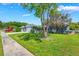 Cozy home with a lush green lawn and mature trees offering shade at 610 Palomas Ave, Ocoee, FL 34761