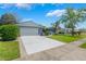 Well-maintained home with a spacious driveway, lush lawn, and mature landscaping at 610 Palomas Ave, Ocoee, FL 34761