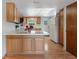 Bright kitchen boasts wood cabinets, essential appliances, and a functional breakfast bar at 610 Palomas Ave, Ocoee, FL 34761