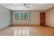 Bright living room featuring hardwood floors and a large window with backyard views at 610 Palomas Ave, Ocoee, FL 34761