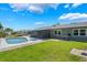 Backyard pool and hot tub with screened-in porch and spacious lawn for outdoor entertaining at 610 Palomas Ave, Ocoee, FL 34761