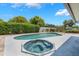Enjoy the pool and spa in a private backyard setting with lush landscaping at 610 Palomas Ave, Ocoee, FL 34761
