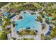 Aerial view of a stunning resort-style pool surrounded by lush tropical landscaping at 14501 Grove Resort Ave # 3735, Winter Garden, FL 34787