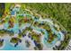 Aerial view of a resort-style pool, lazy river, and lush landscaping at 14501 Grove Resort Ave # 3735, Winter Garden, FL 34787