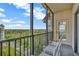 A private balcony with seating offers a serene view of the surrounding greenery and distant buildings at 14501 Grove Resort Ave # 3735, Winter Garden, FL 34787