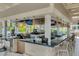 Open-air bar with pendant lighting and barstool seating at 14501 Grove Resort Ave # 3735, Winter Garden, FL 34787