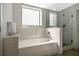 Bright bathroom featuring modern fixtures, shower with glass door, and built-in soaking tub at 14501 Grove Resort Ave # 3735, Winter Garden, FL 34787