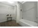 Bathroom with built-in shelving, shower, tub, and lots of towel storage at 14501 Grove Resort Ave # 3735, Winter Garden, FL 34787
