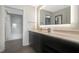Well-lit bathroom featuring a modern vanity, illuminated mirror, and a shower and tub at 14501 Grove Resort Ave # 3735, Winter Garden, FL 34787