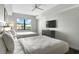 Well-lit bedroom with two beds, mounted TV, and views from the window at 14501 Grove Resort Ave # 3735, Winter Garden, FL 34787