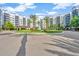 Elegant building entrance featuring palm trees and a well-manicured roundabout for convenient access to the condos at 14501 Grove Resort Ave # 3735, Winter Garden, FL 34787