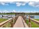 Picturesque dock extending over a tranquil lake with boat slips at 14501 Grove Resort Ave # 3735, Winter Garden, FL 34787