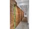 Hallway with textured wood panels and vertical plant accent lighting at 14501 Grove Resort Ave # 3735, Winter Garden, FL 34787