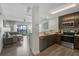 A modern kitchen open to the living area with stainless steel appliances and wood grain floors at 14501 Grove Resort Ave # 3735, Winter Garden, FL 34787