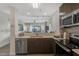 Stylish kitchen featuring stainless steel appliances, quartz countertops, and an open view to the living area at 14501 Grove Resort Ave # 3735, Winter Garden, FL 34787