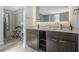 Sleek main bathroom with double vanity, backlit mirror, and spacious walk-in closet at 14501 Grove Resort Ave # 3735, Winter Garden, FL 34787