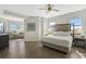 Bright and airy main bedroom features wood floors, a ceiling fan, and plenty of natural light at 14501 Grove Resort Ave # 3735, Winter Garden, FL 34787