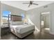 Beautifully lit main bedroom includes wood floors, a plush headboard and an adjacent bathroom at 14501 Grove Resort Ave # 3735, Winter Garden, FL 34787
