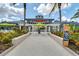 Inviting restaurant exterior featuring lush landscaping, pergola, and decorative surfboard at 14501 Grove Resort Ave # 3735, Winter Garden, FL 34787
