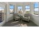 Comfortable sitting area with two cozy armchairs, side table and natural light from many windows at 14501 Grove Resort Ave # 3735, Winter Garden, FL 34787