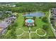 Community pool and lounge area with lush landscaping, alongside a pond and surrounding residences at 14717 Royal Poinciana Dr, Orlando, FL 32828