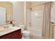 Bathroom with single sink vanity, toilet, and shower-tub combo with neutral colors at 14717 Royal Poinciana Dr, Orlando, FL 32828