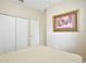 Cozy bedroom with neutral decor and closet space, perfect for relaxation at 14717 Royal Poinciana Dr, Orlando, FL 32828