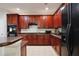 Well-equipped kitchen with abundant wooden cabinetry and a black refrigerator at 14717 Royal Poinciana Dr, Orlando, FL 32828