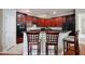 Eat-in kitchen featuring custom cabinetry, modern appliances, and breakfast bar with seating at 14717 Royal Poinciana Dr, Orlando, FL 32828