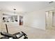 Spacious living room with carpet flooring, chandelier, and pass-through to the kitchen at 14717 Royal Poinciana Dr, Orlando, FL 32828