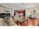 Comfortable living room featuring hardwood floors and open layout leading to the kitchen and dining area at 14717 Royal Poinciana Dr, Orlando, FL 32828