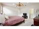 Spacious main bedroom featuring a ceiling fan, closet, and comfortable carpet flooring at 14717 Royal Poinciana Dr, Orlando, FL 32828